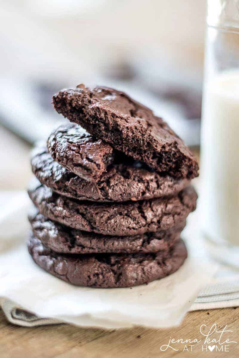 A stack of chocolate cookies, with one broken in half on top 
