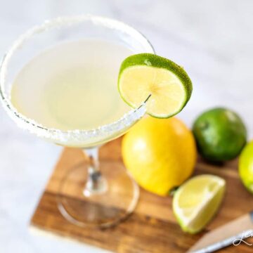 Margarita in a stemmed glass with a lemon and sugar around the rim