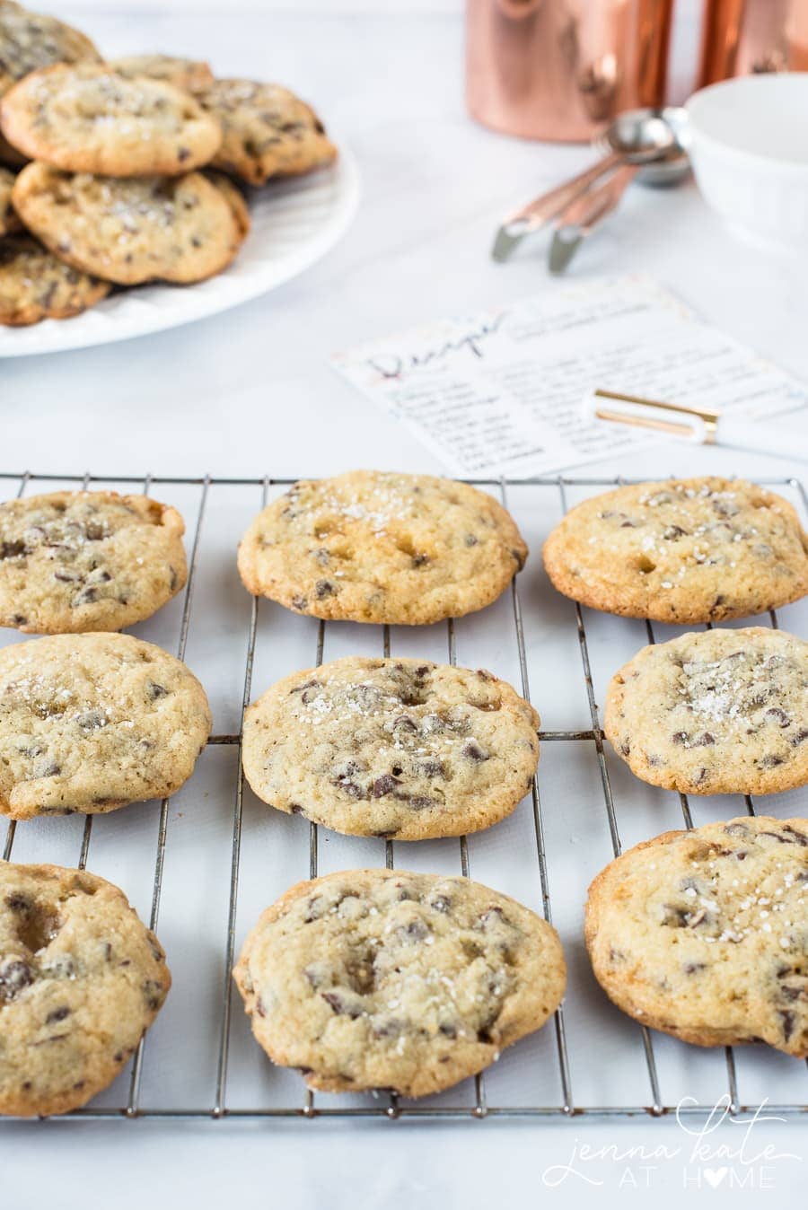 A group of cookies, resting on a wire cooling rack on the countertop