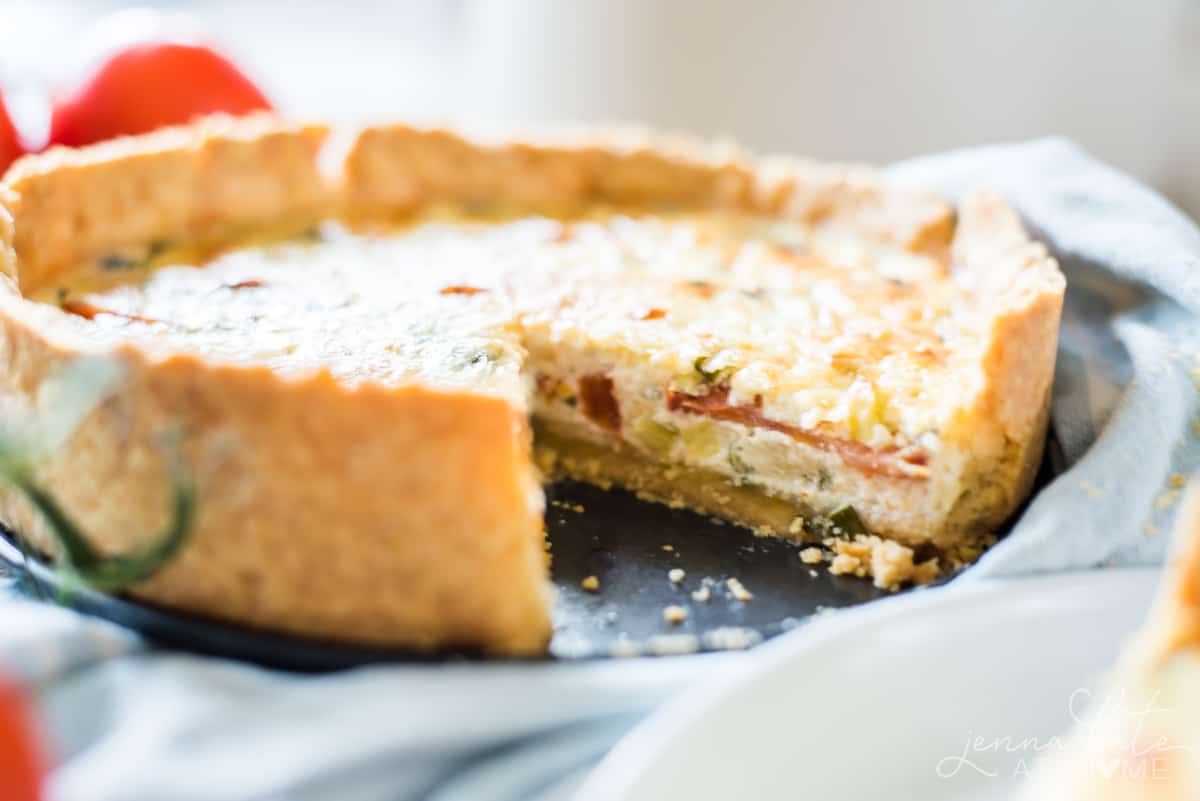 Inside of pie filled with creamy filling and fresh summer tomatoes