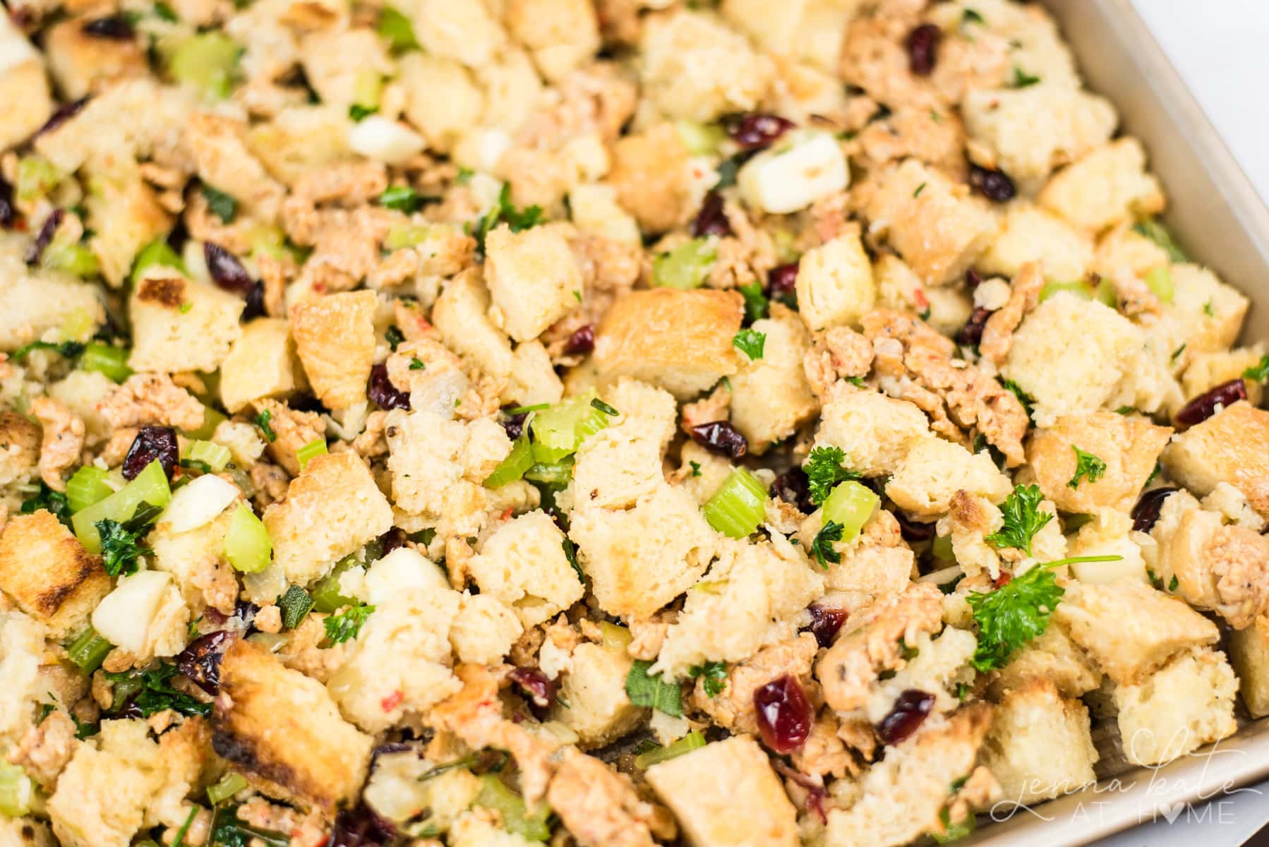 Close up of bread cubes, herbs and cranberries
