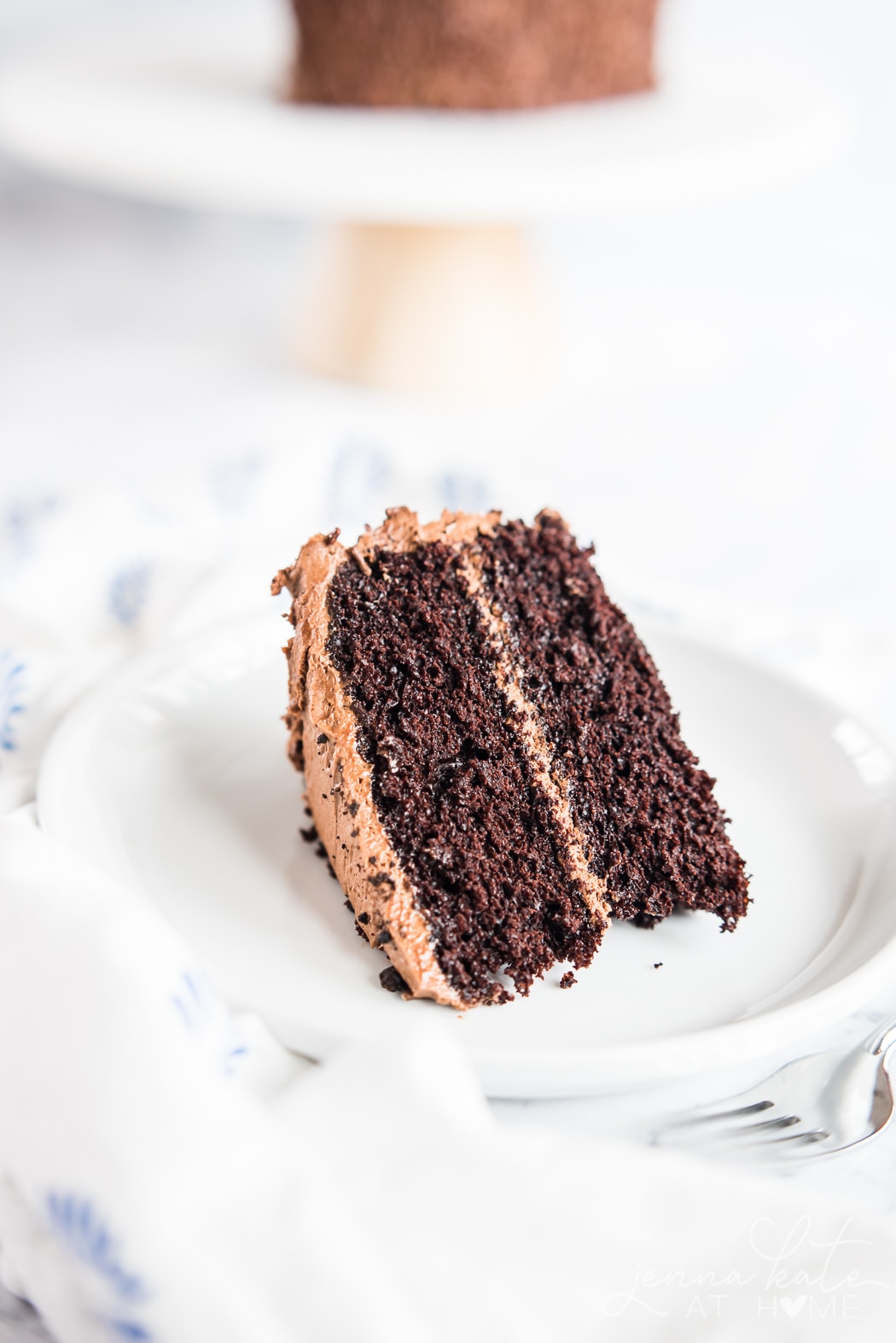 Slice of homemade chocolate cake with buttercream frosting