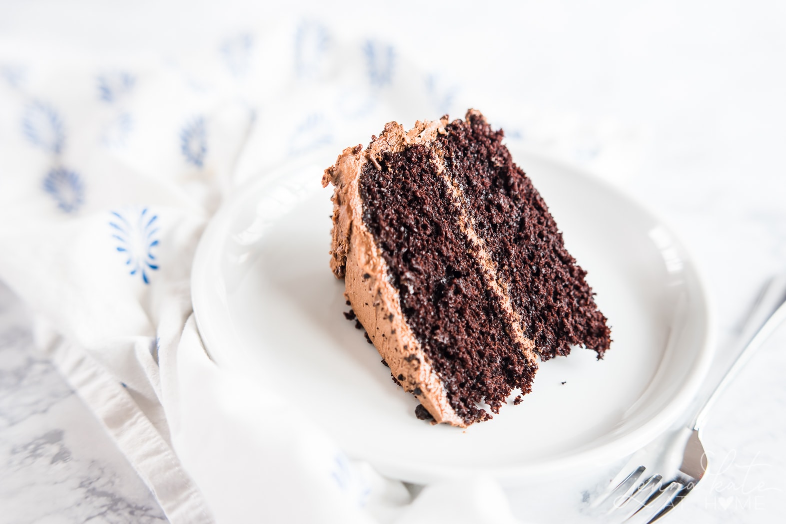 Easy chocolate birthday cake recipe, slice of moist cake on a plate