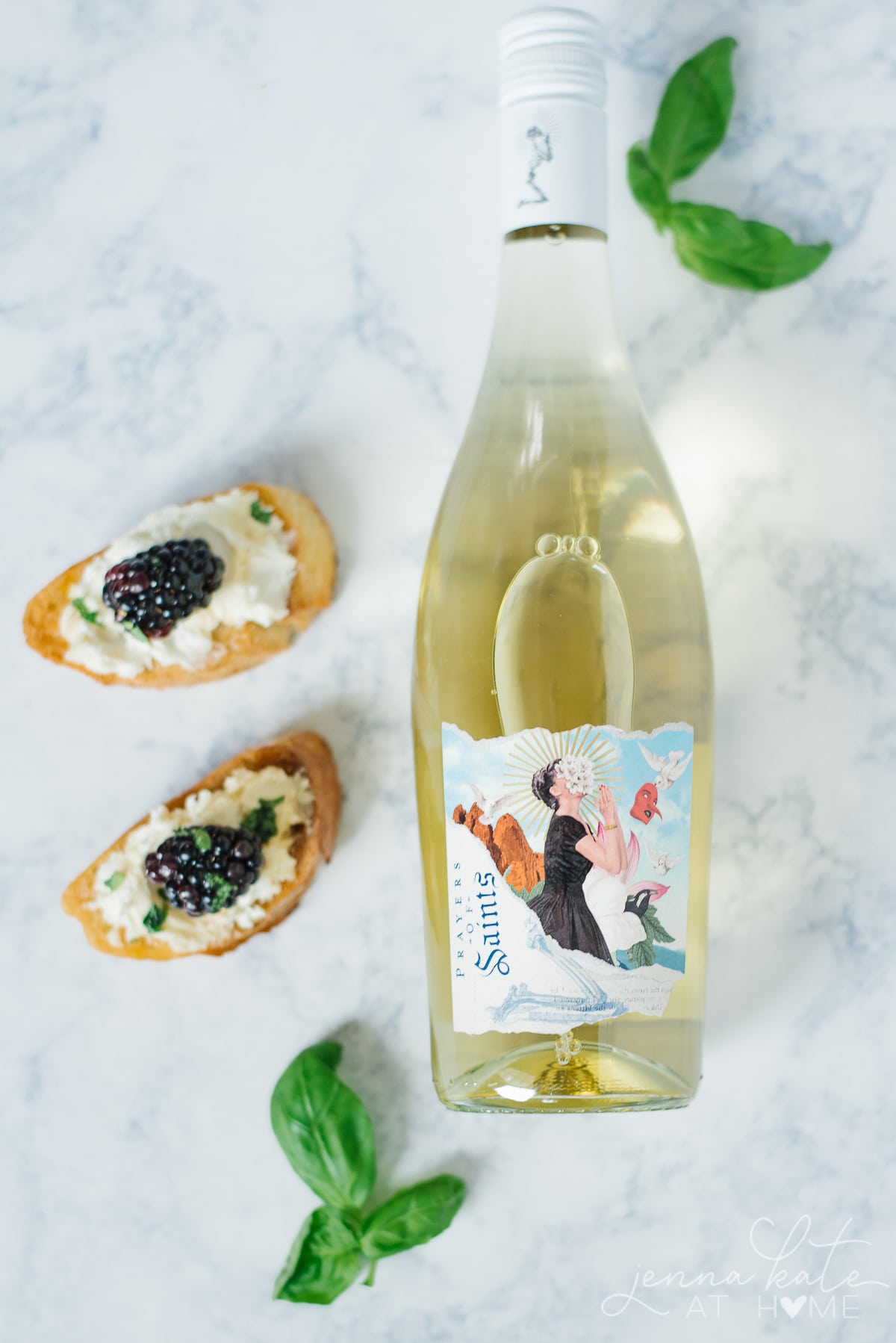 Bottle of white wine paired with fruit and goat cheese crostini
