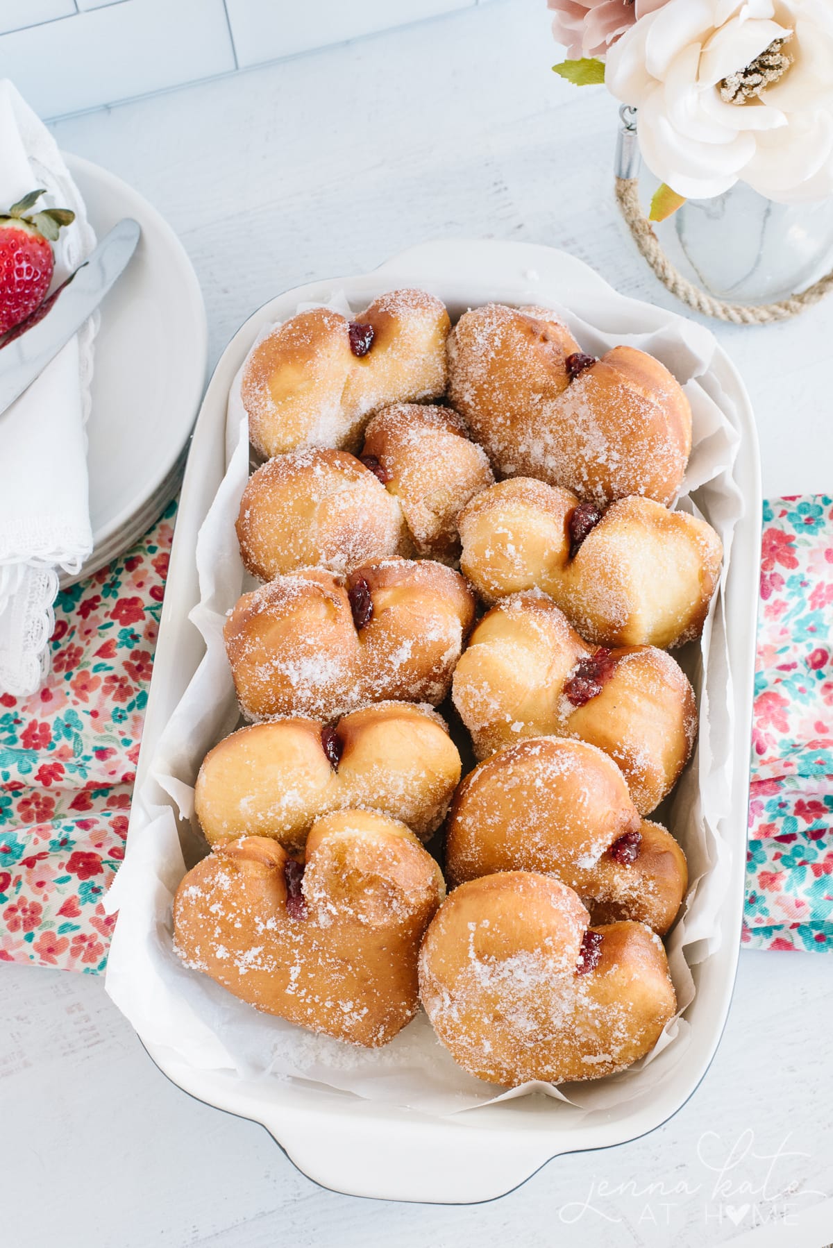 Doughnuts lined up neatly in a baking dish