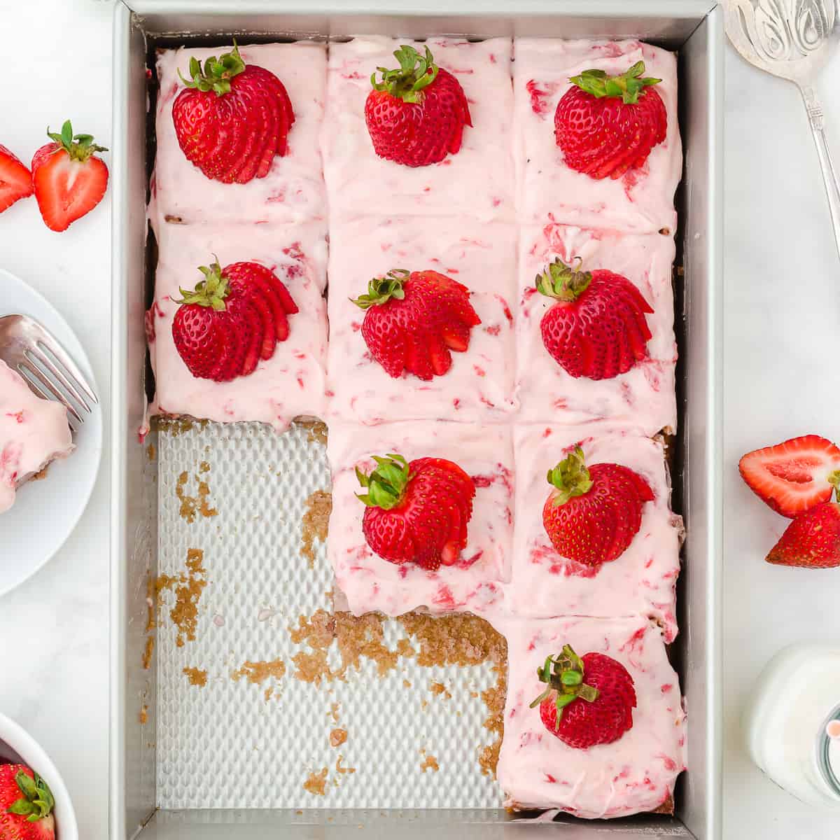 strawberry cake in pan with slices removed