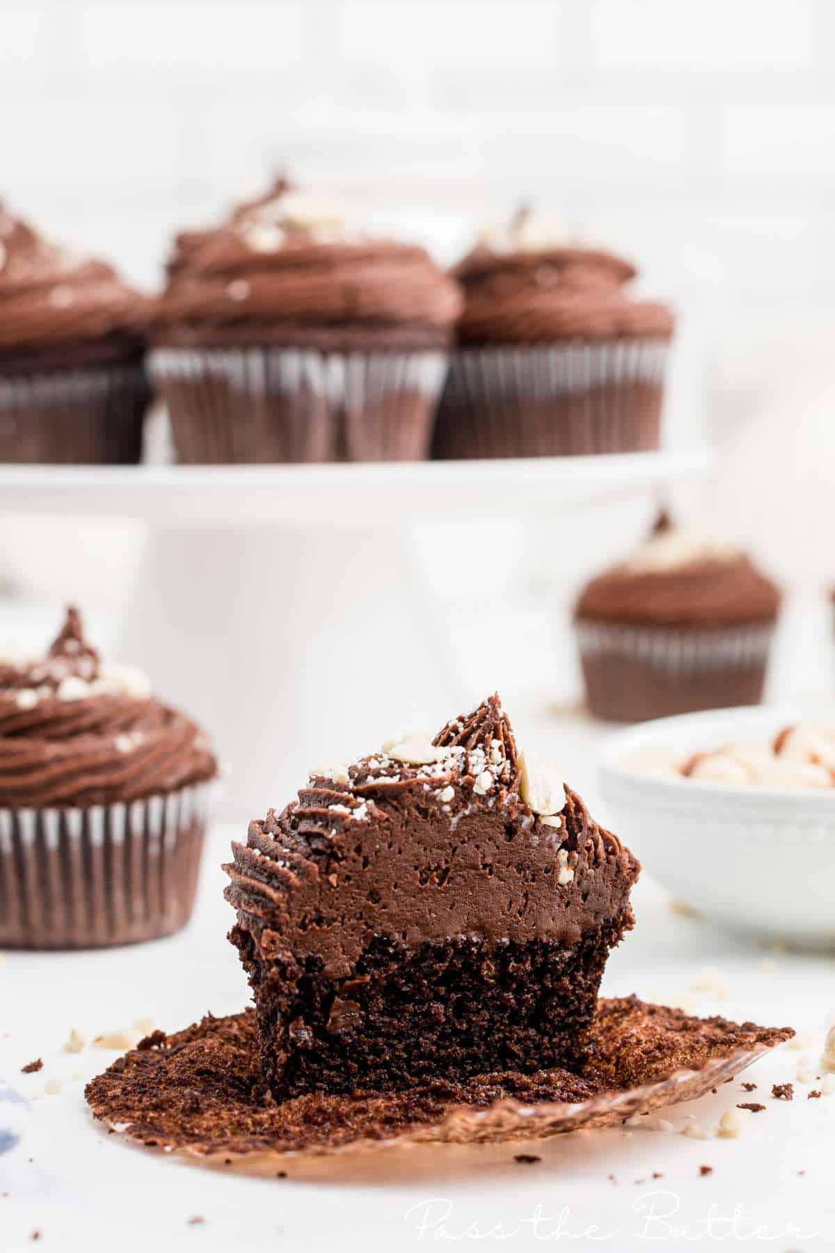 a chocolate cupcake that has been cut in half, it has peanut butter frosting