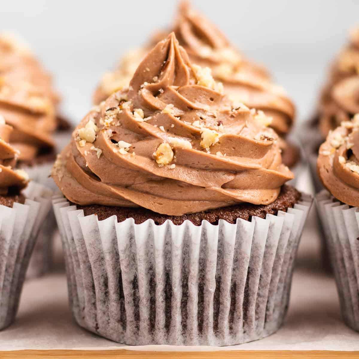 nutella cupcake with nutella buttercream frosting and hazelnuts on top