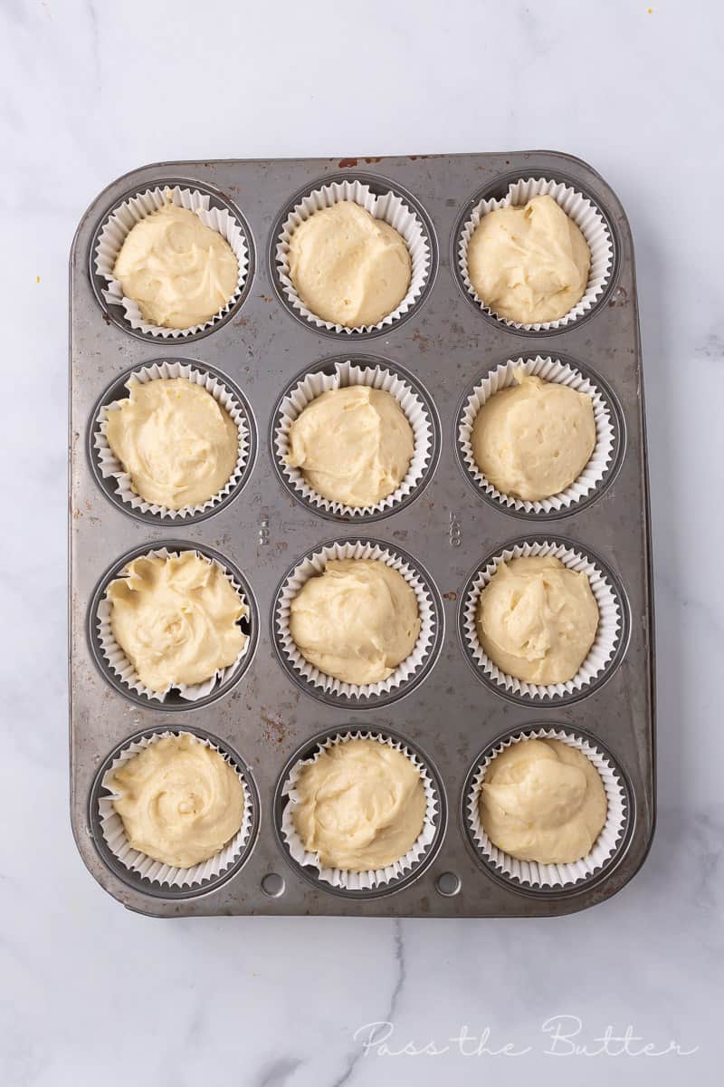 muffin pan filled with paper liners and cupcake batter