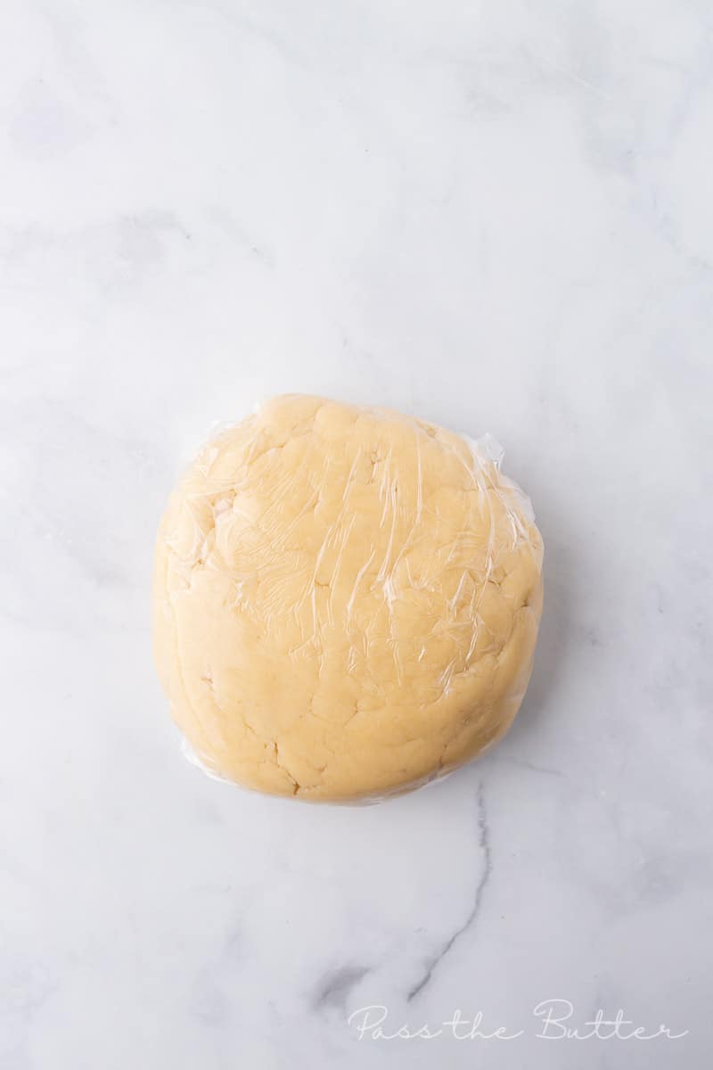 pie dough rolled in a ball and covered with plastic wrap.