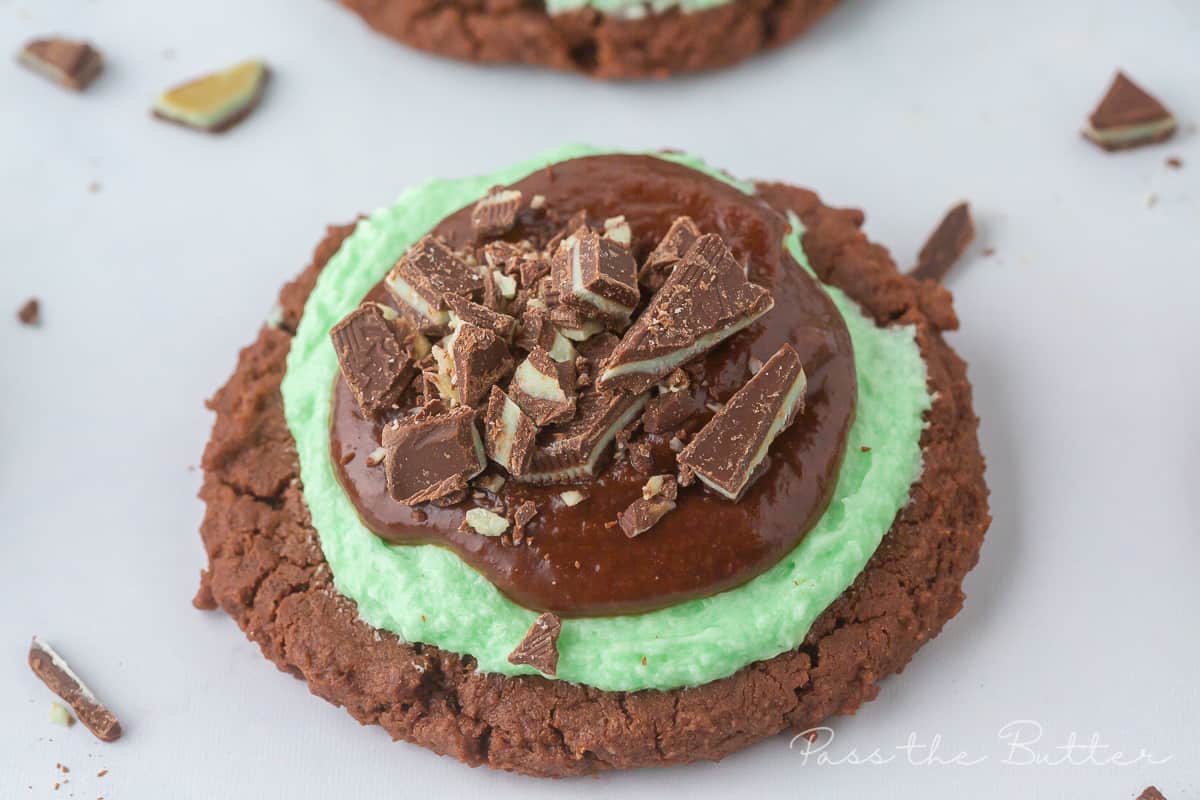 Grasshopper Cookie on a marble counter surrounded by andes mint pieces. 