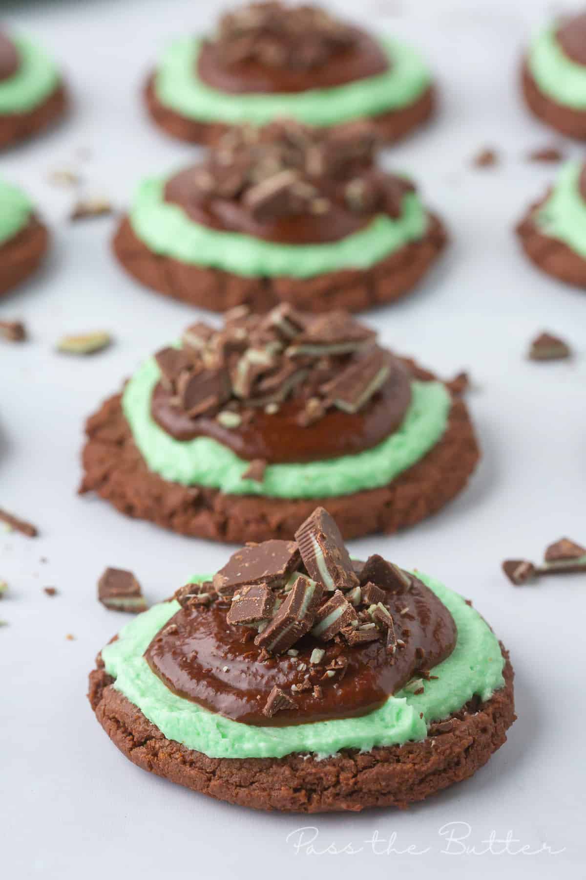 Grasshopper cookies lined up on a marble counter top.